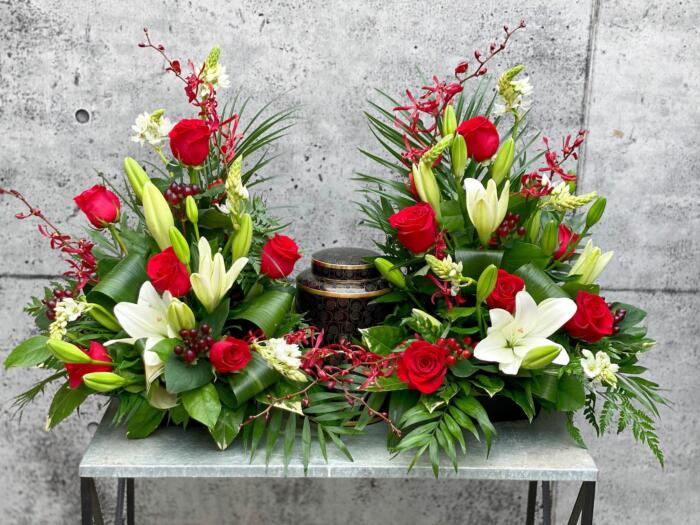 The Watering Can | A red and white cremation design that rise up on both sides of the urn.