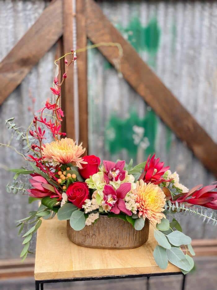 The Watering Can | A graceful European style arrangement in red featuring both cymbidium and annabelle orchids.