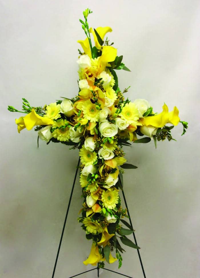 The Watering Can | A yellow and white floral cross.